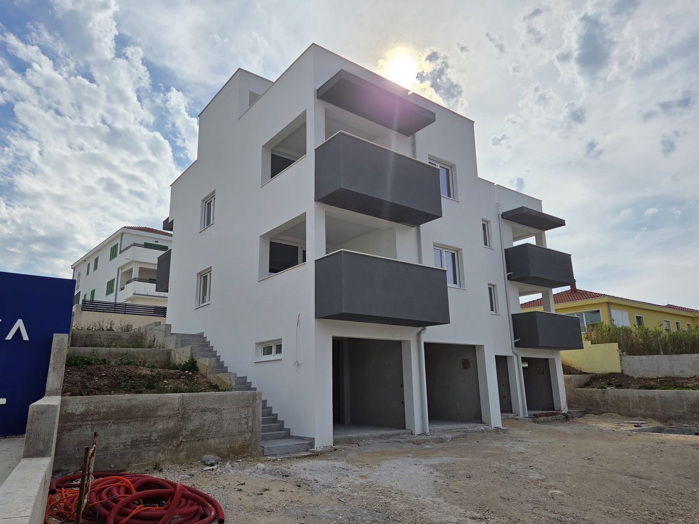Apartment building with sea-view balconies and ground-level garages